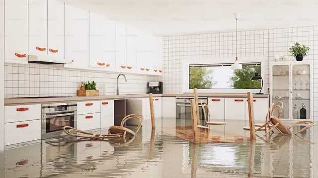 Bright kitchen with water covering the floor after a leak